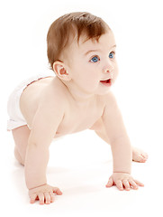 Image showing crawling baby boy looking up