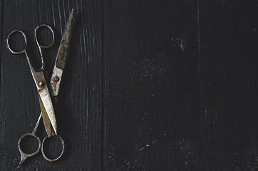 Image showing Old scissors on wooden background