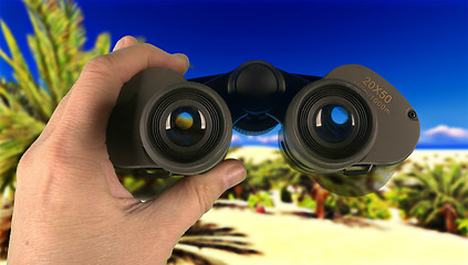 Image showing Man scouring area through his binoculars 