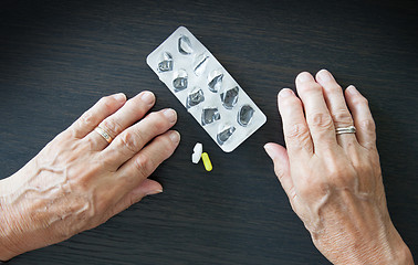 Image showing Elderly person taking medication