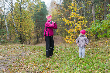 Image showing Woman with girl doing aerobics in the autumn park