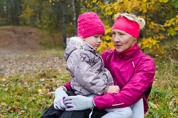 Image showing Woman with girl doing aerobics in the autumn park