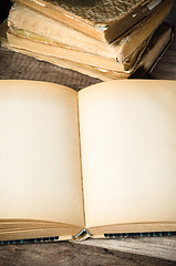 Image showing open old book on a wooden surface 