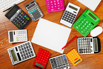 Image showing Calculators lying on the wooden flooring