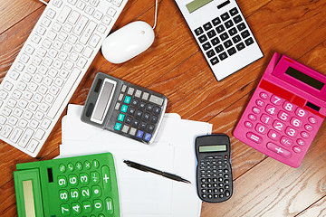 Image showing Calculators lying on the wooden flooring