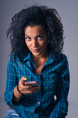 Image showing Woman texting on her cell phone