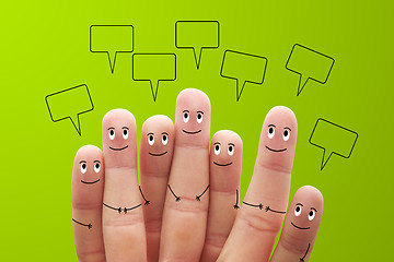 Image showing Happy finger smileys with speech bubbles on green background