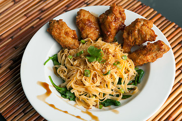 Image showing Chicken Wings with Noodles and Spinach