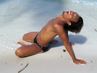 Image showing Suntanning tourist on beach