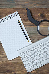 Image showing notebook, pen, magnifying glass and computer keyboard