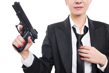 Image showing beautiful girl gangster holding a gun. Classic suit and hat. isolated on white 