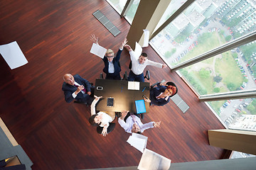 Image showing top view of business people group throwing dociments in air