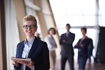 Image showing business woman with glasses  at office with tablet  in front  as