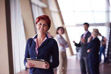 Image showing business woman  at office with tablet  in front  as team leader