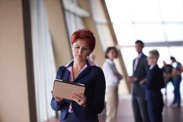 Image showing business woman  at office with tablet  in front  as team leader