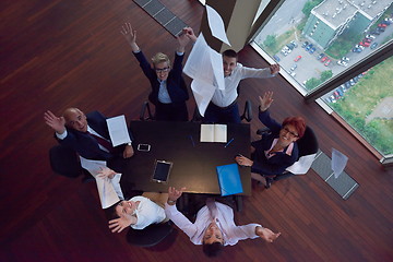 Image showing top view of business people group throwing dociments in air