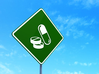 Image showing Medicine concept: Pills on road sign background