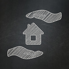 Image showing Insurance concept: House And Palm on chalkboard background