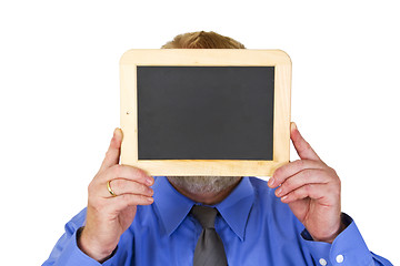 Image showing Businessman holding a blank Blackboard