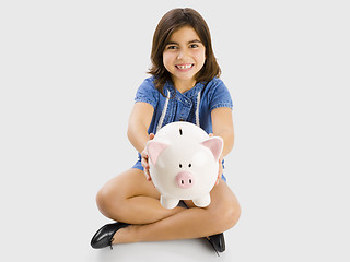 Image showing Young girl holding a piggybank