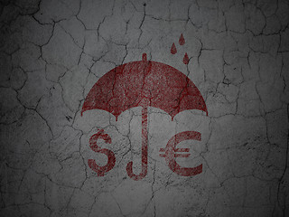 Image showing Safety concept: Money And Umbrella on grunge wall background