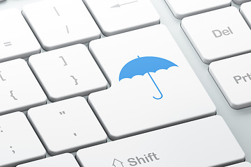 Image showing Protection concept: Umbrella on computer keyboard background