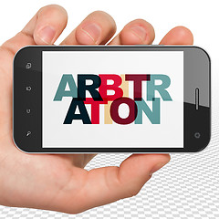 Image showing Law concept: Hand Holding Smartphone with Arbitration on  displa