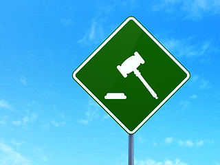 Image showing Law concept: Gavel on road sign background