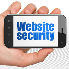 Image showing Web design concept: Hand Holding Smartphone with Website Security on display