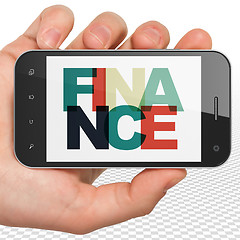 Image showing Banking concept: Hand Holding Smartphone with Finance on  display