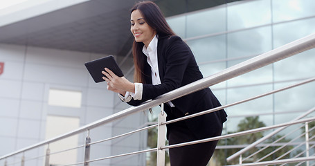 Image showing Young businesswoman browsing on her tablet