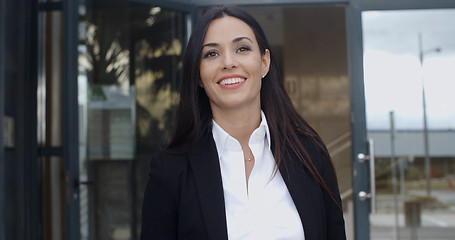 Image showing Young businesswoman exiting a modern office