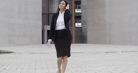 Image showing Young businesswoman walking towards the camera