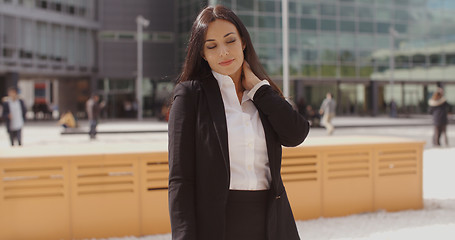 Image showing Smart young businesswoman rubbing her neck
