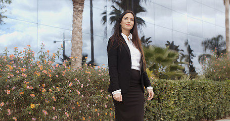 Image showing Stylish businesswoman standing outside her office