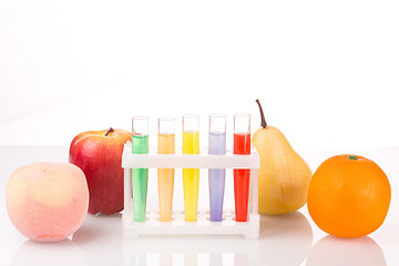 Image showing Fruit close chemical test tubes. Genetic Engineering. pesticides in foods