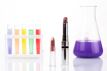 Image showing chemical test tubes and lipstick. harmful cosmetics.