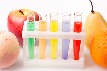 Image showing Fruit close chemical test tubes. Genetic Engineering. pesticides in foods