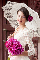 Image showing Beautiful young smiling woman with flowers