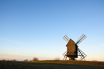 Image showing Old wooden windmill in sunlight