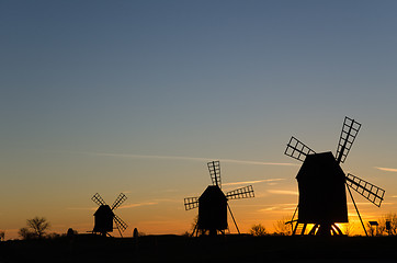 Image showing Traditional windmills in a row by sunset