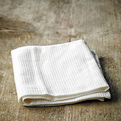 Image showing White towel on wooden table