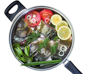 Image showing Fish and components for her preparation in a large skillet.