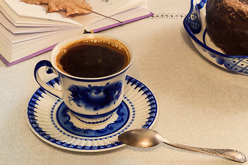 Image showing A Cup of black coffee and cake on the table.