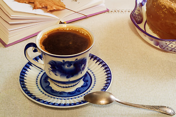 Image showing A Cup of black coffee and cake on the table.