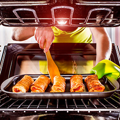 Image showing Cooking in the oven at home.