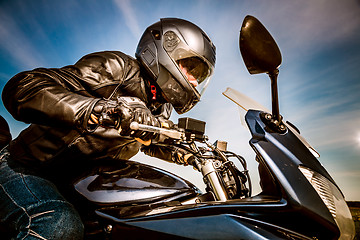 Image showing Biker racing on the road