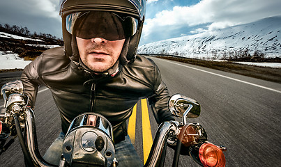 Image showing Biker racing on the road