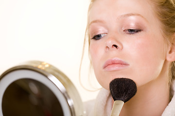 Image showing Putting on makeup