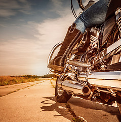 Image showing Biker girl riding on a motorcycle